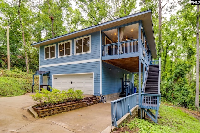 3308 Keenan Dr, Columbia, SC 29201 - view of front of property featuring stairway, an attached garage, concrete driveway, and ceiling fan