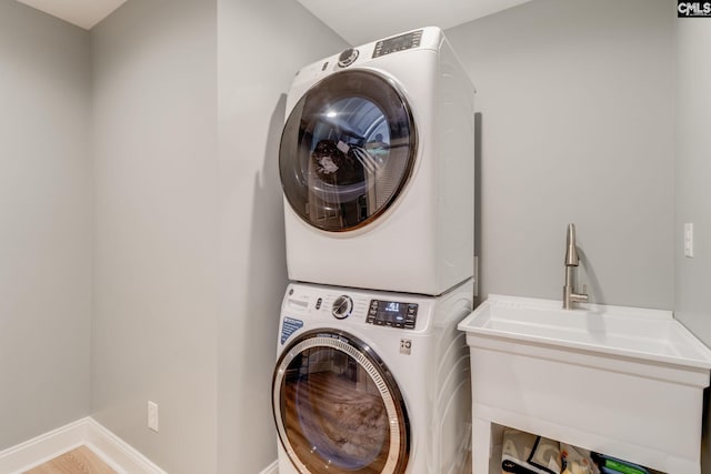 3308 Keenan Dr, Columbia, SC 29201 - laundry room featuring estacked washer and dryer, baseboards, and wood finished floors