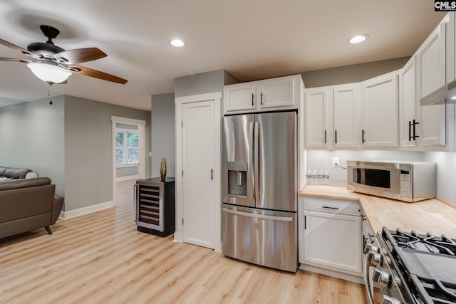 3308 Keenan Dr, Columbia, SC 29201 - kitchen featuring stainless steel appliances, light wood-style flooring, white cabinetry, a ceiling fan, and recessed lighting