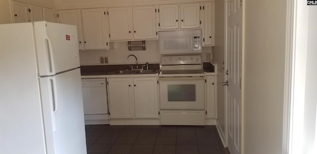 1801 Tall Pines Cir, Columbia, SC 29205 - kitchen featuring white appliances, dark tile patterned flooring, a sink, and white cabinetry