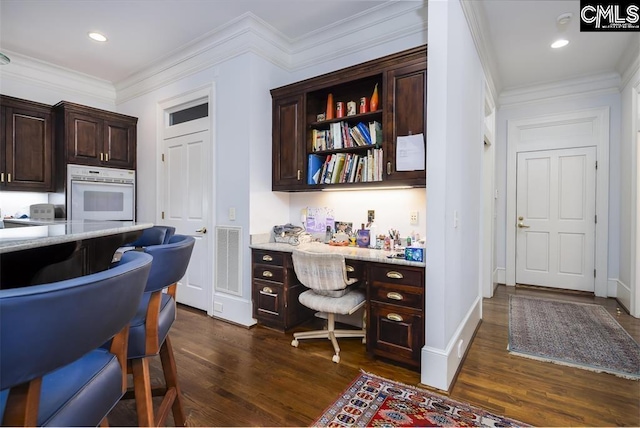 7021 Cleaton Rd, Columbia, SC 29206 - home office with dark wood-type flooring, built in study area, ornamental molding, and recessed lighting