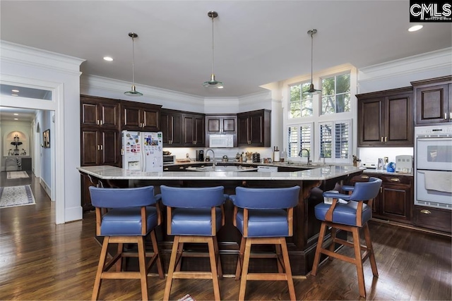 7021 Cleaton Rd, Columbia, SC 29206 - kitchen featuring white appliances, a sink, dark brown cabinets, dark wood finished floors, and crown molding