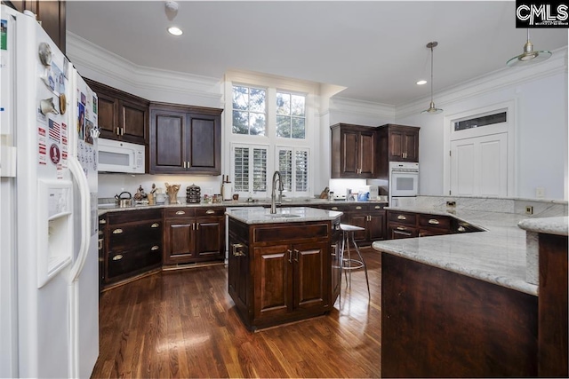 7021 Cleaton Rd, Columbia, SC 29206 - kitchen featuring white appliances, a sink, an island with sink, dark wood finished floors, and ornamental molding
