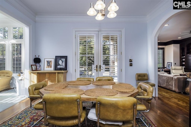 7021 Cleaton Rd, Columbia, SC 29206 - dining room with arched walkways, crown molding, wood finished floors, healthy amount of natural light, and a chandelier
