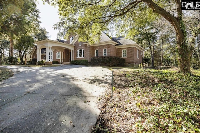 7021 Cleaton Rd, Columbia, SC 29206 - view of front of house with brick siding, concrete driveway, and a porch