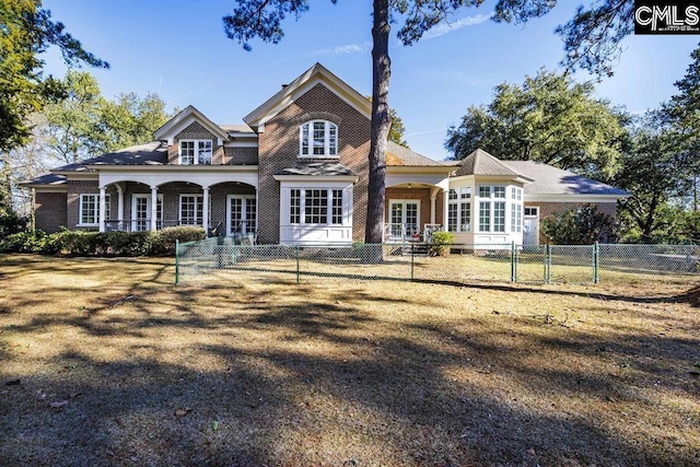7021 Cleaton Rd, Columbia, SC 29206 - rear view of property with a fenced front yard, french doors, covered porch, brick siding, and a carport