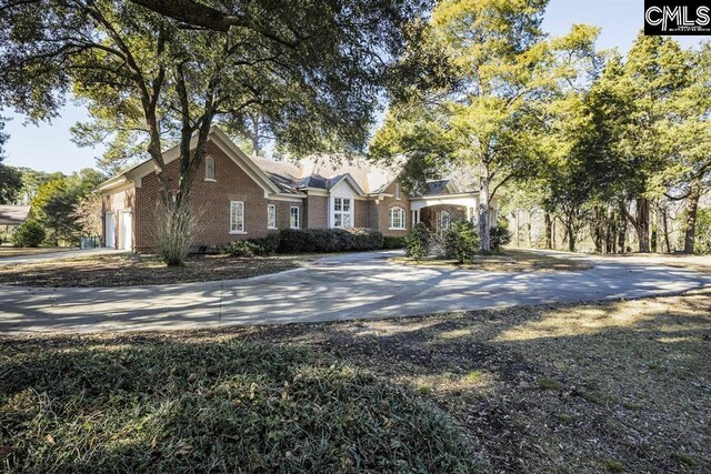 7021 Cleaton Rd, Columbia, SC 29206 - view of front of house featuring driveway, an attached garage, and brick siding