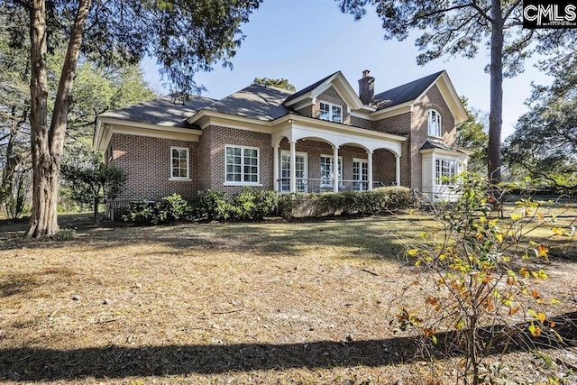7021 Cleaton Rd, Columbia, SC 29206 - view of front facade with brick siding, a chimney, and a porch