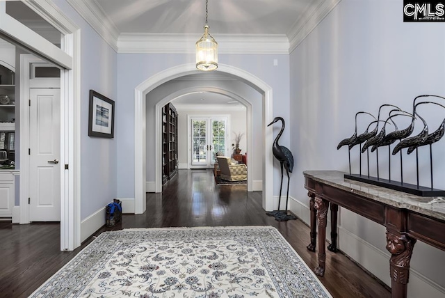 7021 Cleaton Rd, Columbia, SC 29206 - foyer entrance featuring arched walkways, dark wood finished floors, ornamental molding, and baseboards