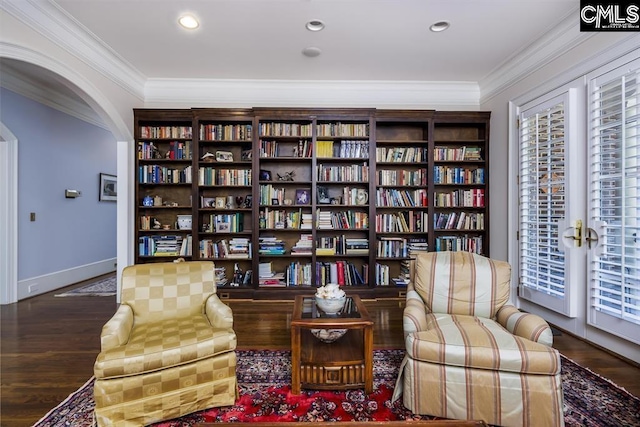7021 Cleaton Rd, Columbia, SC 29206 - living area featuring arched walkways, crown molding, wood finished floors, bookshelves, and recessed lighting
