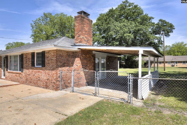 2667 Ford St, Sumter, SC 29154 - view of side of property featuring a chimney, brick siding, and a gate