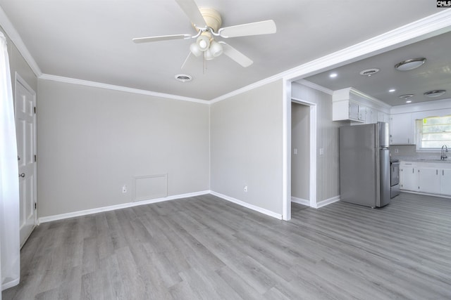 2667 Ford St, Sumter, SC 29154 - unfurnished living room with a sink, ornamental molding, a ceiling fan, light wood-style flooring, and baseboards