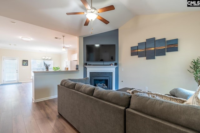 209 Windsor Trace Dr, Columbia, SC 29209 - living room featuring dark wood-type flooring, lofted ceiling, ceiling fan, a glass covered fireplace, and a chandelier