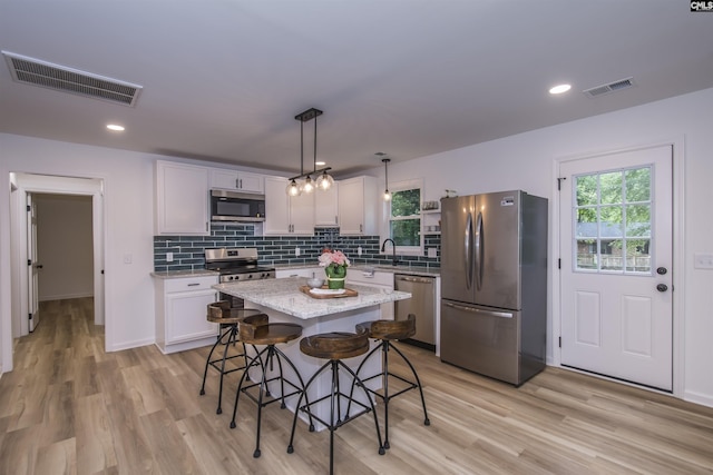 108 Bickleigh Rd, Irmo, SC 29063 - kitchen featuring stainless steel appliances, light wood-type flooring, a kitchen breakfast bar, backsplash, and recessed lighting