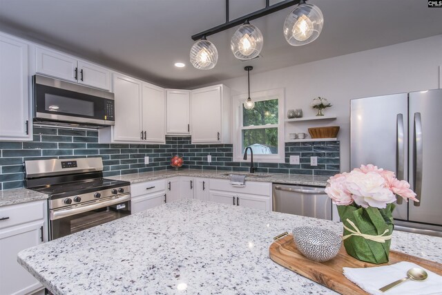108 Bickleigh Rd, Irmo, SC 29063 - kitchen featuring appliances with stainless steel finishes, a sink, white cabinets, tasteful backsplash, and light stone counters