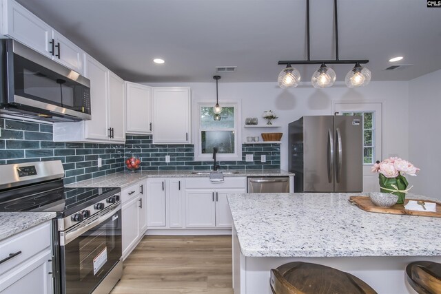 108 Bickleigh Rd, Irmo, SC 29063 - kitchen featuring stainless steel appliances, a sink, a breakfast bar, white cabinets, and recessed lighting