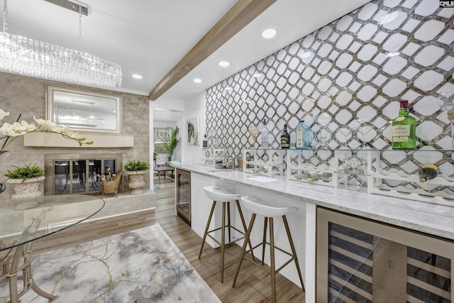 225 Park Shore Dr, Columbia, SC 29223 - indoor bar with beverage cooler, wood finished floors, recessed lighting, a chandelier, and pendant lighting