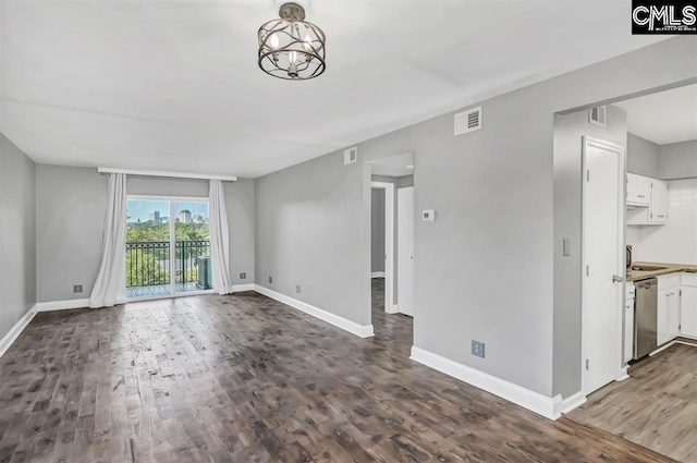 619 King St Unit 608, Columbia, SC 29205 - unfurnished living room with wood finished floors, baseboards, and a chandelier