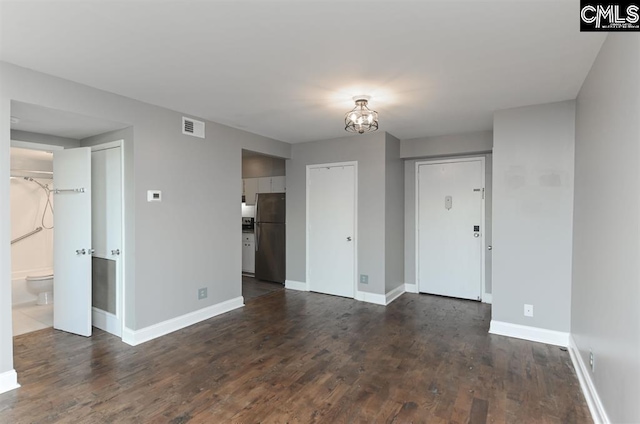 619 King St Unit 608, Columbia, SC 29205 - spare room featuring dark wood-style flooring, baseboards, and a chandelier
