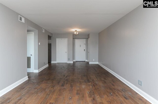 619 King St Unit 608, Columbia, SC 29205 - spare room featuring dark wood finished floors, baseboards, and a chandelier