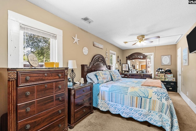 319 Graham St, West Columbia, SC 29169 - bedroom with light colored carpet, attic access, a textured ceiling, a ceiling fan, and baseboards