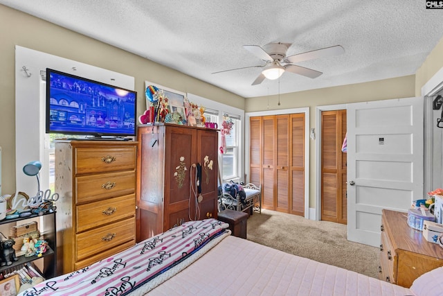 319 Graham St, West Columbia, SC 29169 - carpeted bedroom with multiple closets, a textured ceiling, and a ceiling fan