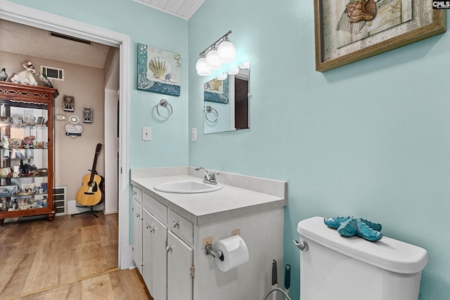 319 Graham St, West Columbia, SC 29169 - bathroom with toilet, vanity, and wood finished floors