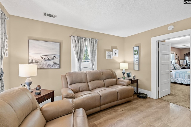 319 Graham St, West Columbia, SC 29169 - living area with light wood finished floors, a textured ceiling, and baseboards