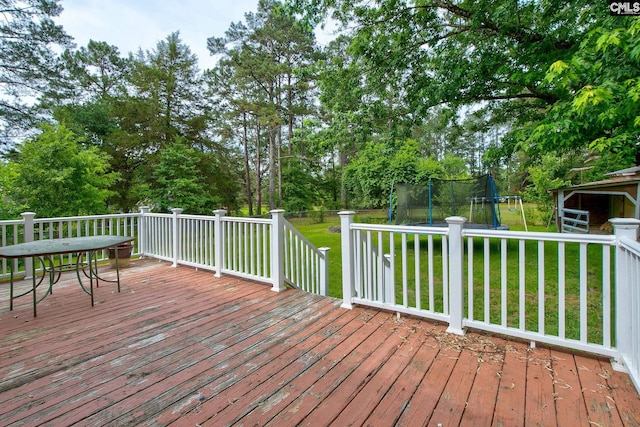 589 White Pines Cir, Camden, SC 29020 - deck with a trampoline, a lawn, and view of scattered trees