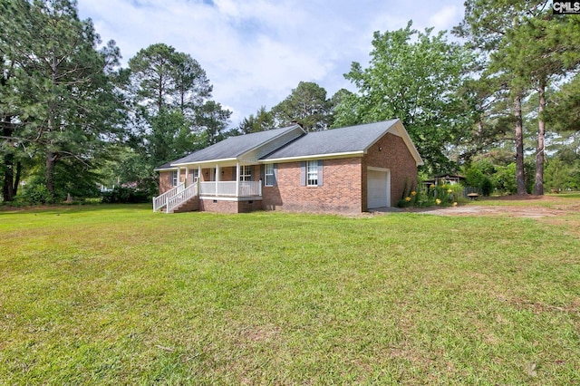 589 White Pines Cir, Camden, SC 29020 - view of front of house with a porch, brick siding, a garage, a front lawn, and driveway