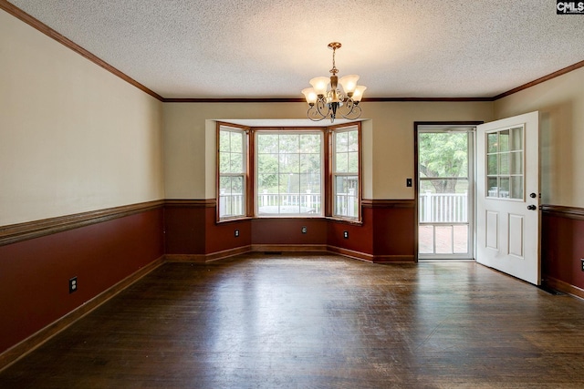 589 White Pines Cir, Camden, SC 29020 - unfurnished dining area with dark wood-type flooring, a chandelier, a textured ceiling, crown molding, and baseboards