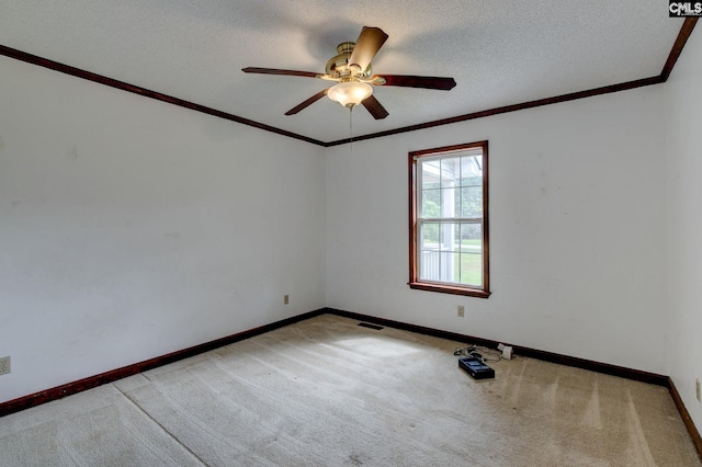 589 White Pines Cir, Camden, SC 29020 - spare room featuring carpet floors, baseboards, ceiling fan, a textured ceiling, and ornamental molding