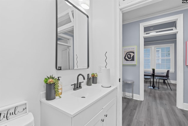 618 Joan St, Columbia, SC 29203 - half bath with vanity, wood finished floors, toilet, and baseboards
