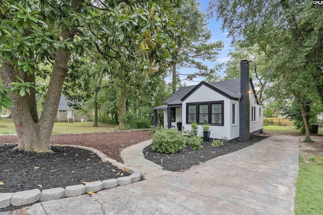 618 Joan St, Columbia, SC 29203 - view of side of home with a chimney, concrete driveway, and roof with shingles