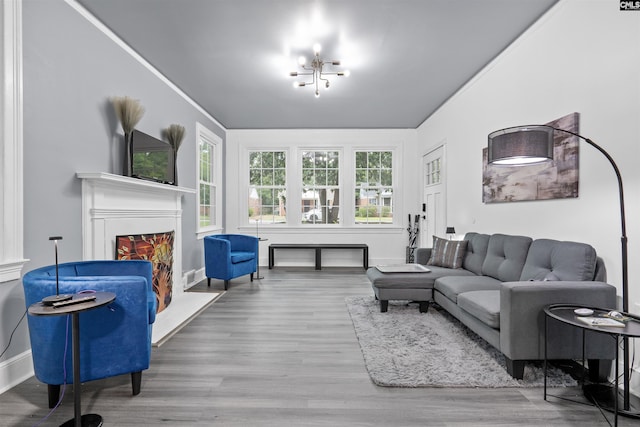 618 Joan St, Columbia, SC 29203 - living room featuring wood finished floors, baseboards, a lit fireplace, and a chandelier