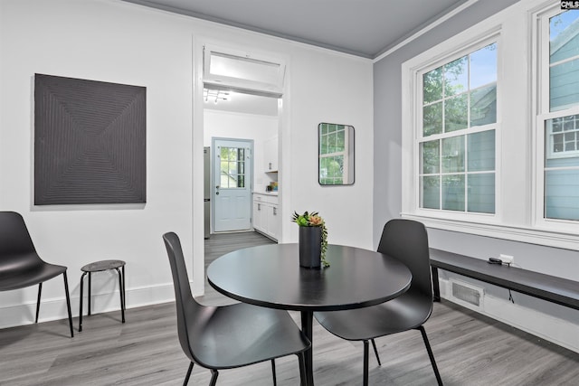 618 Joan St, Columbia, SC 29203 - dining room with light wood-style floors, crown molding, and baseboards