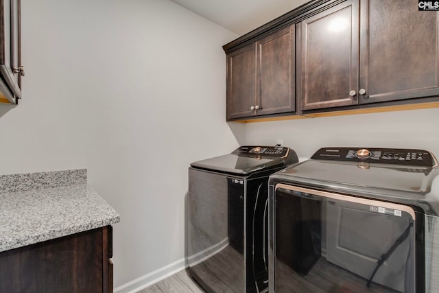 137 Brockway Dr, Columbia, SC 29229 - laundry area with cabinet space, washing machine and dryer, baseboards, and light wood-style floors