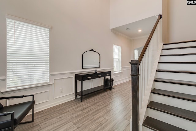 137 Brockway Dr, Columbia, SC 29229 - staircase featuring wood finished floors, ornamental molding, a decorative wall, and wainscoting