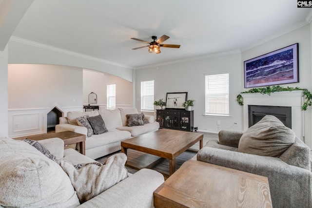 137 Brockway Dr, Columbia, SC 29229 - living room featuring ornamental molding, a fireplace, a ceiling fan, arched walkways, and wood finished floors