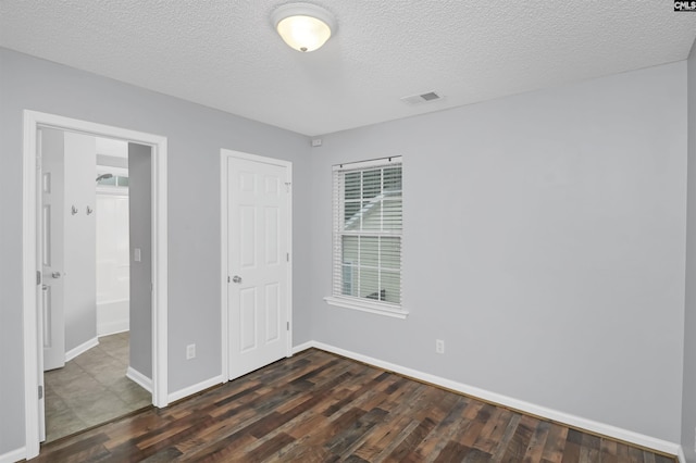 140 Otago Way W, Columbia, SC 29170 - unfurnished bedroom with dark wood finished floors, baseboards, and a textured ceiling
