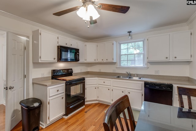 2241 Atascadero Dr, Columbia, SC 29206 - kitchen with black appliances, a sink, a ceiling fan, light wood finished floors, and white cabinetry