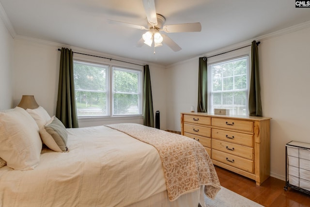 2241 Atascadero Dr, Columbia, SC 29206 - bedroom featuring multiple windows, dark wood-style flooring, crown molding, ceiling fan, and baseboards