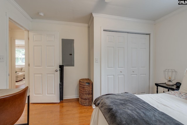 2241 Atascadero Dr, Columbia, SC 29206 - bedroom with electric panel, light wood-type flooring, crown molding, a closet, and baseboards