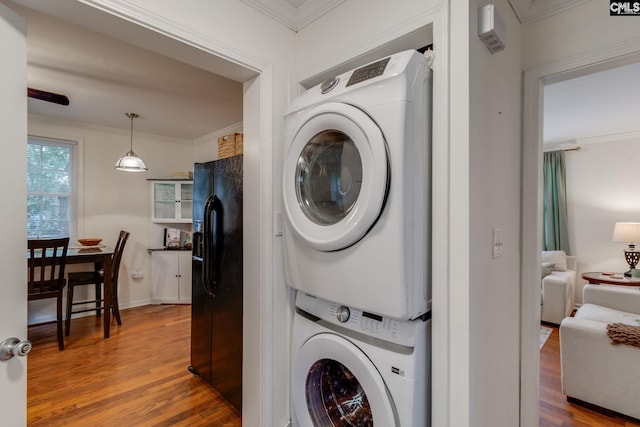 2241 Atascadero Dr, Columbia, SC 29206 - washroom with stacked washer and clothes dryer, wood finished floors, and crown molding