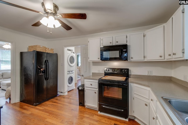2241 Atascadero Dr, Columbia, SC 29206 - kitchen featuring black appliances, stacked washing machine and dryer, a ceiling fan, light wood-type flooring, and crown molding