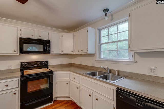 2241 Atascadero Dr, Columbia, SC 29206 - kitchen featuring black appliances, a sink, white cabinets, and light countertops