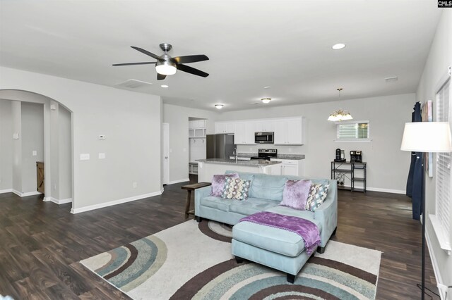 246 Harvest Glen Ln, West Columbia, SC 29169 - living room featuring arched walkways, dark wood-style floors, a ceiling fan, baseboards, and recessed lighting