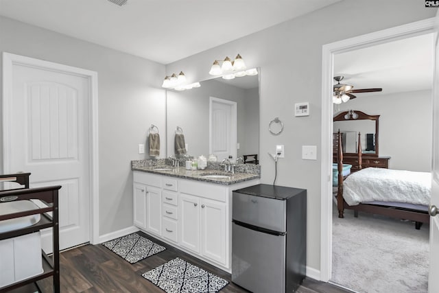 246 Harvest Glen Ln, West Columbia, SC 29169 - full bathroom with connected bathroom, double vanity, wood finished floors, a ceiling fan, and baseboards