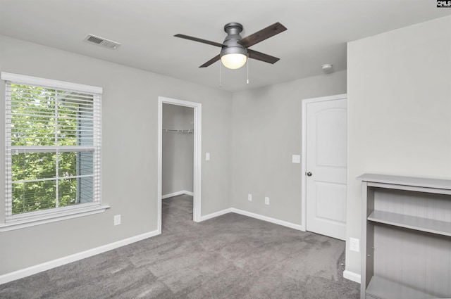 246 Harvest Glen Ln, West Columbia, SC 29169 - unfurnished bedroom featuring carpet, baseboards, a walk in closet, and a ceiling fan