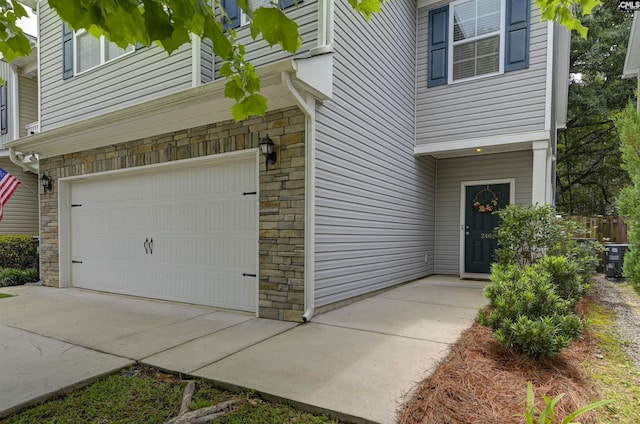 246 Harvest Glen Ln, West Columbia, SC 29169 - doorway to property with an attached garage and stone siding